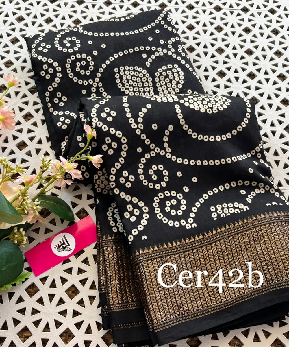 "Black Bhagalpuri saree with allover Bandhani prints and zari woven border, a fusion of traditional elegance and contemporary style, perfect for any occasion."