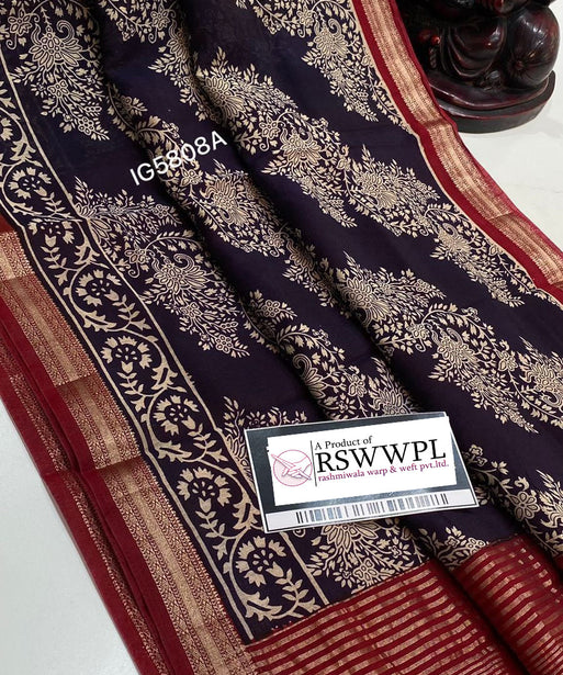 "Elegant Dola silk saree with leaf print, tassels, blue, red, and white, exuding timeless sophistication."