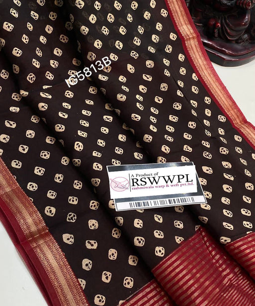 "Brown and white Bagh print Banarasi saree with intricate zari border, epitome of elegance and tradition."