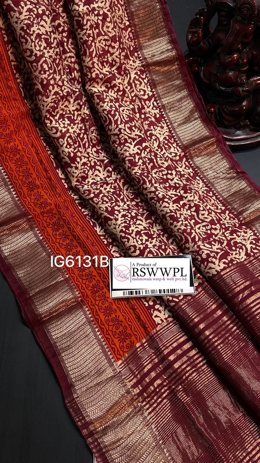 Rosy brown Dola silk saree with allover Ajrakh prints and zari-woven floral border, exuding elegance and charm.